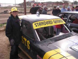 Carol's racing hat matches the Standard Garage sponsored #84's racing colors.