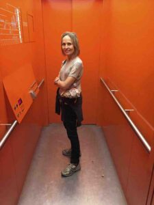 carol in orange elevator