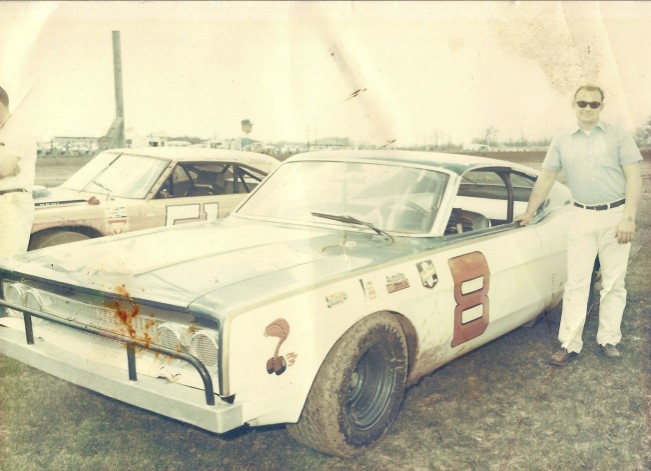 I bought this photo from a vendor at the Sterling Speed Bowl in Sterling, Illinois in 1970. This was the first year Darrell raced Ford Torinos. I thought this was a beautiful stock car for its time. Note the glass windshield and windshield wiper. That's Roger Dolan pitted next to Darrell. 